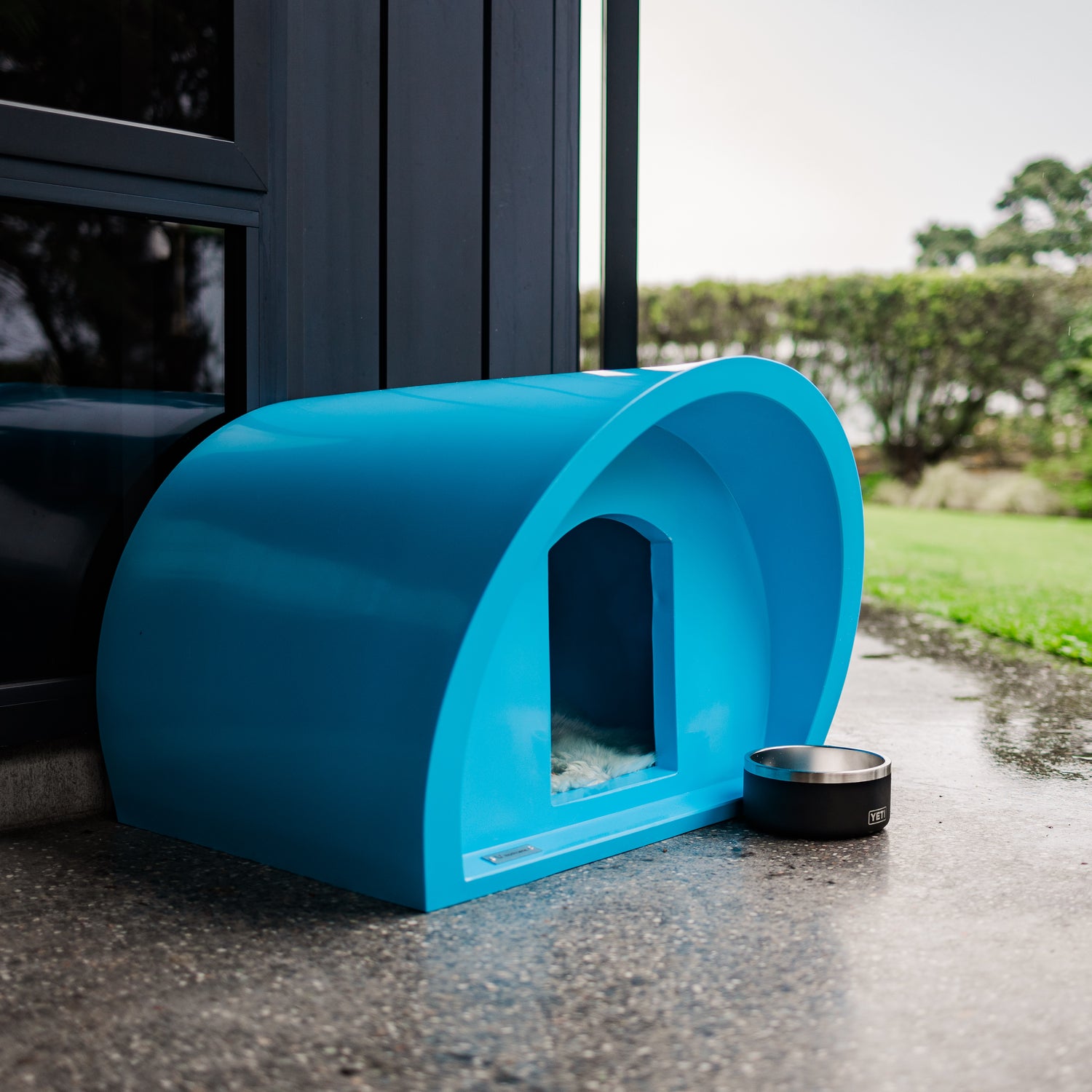 A small cat house in a light blue colour. Modscene kennels.