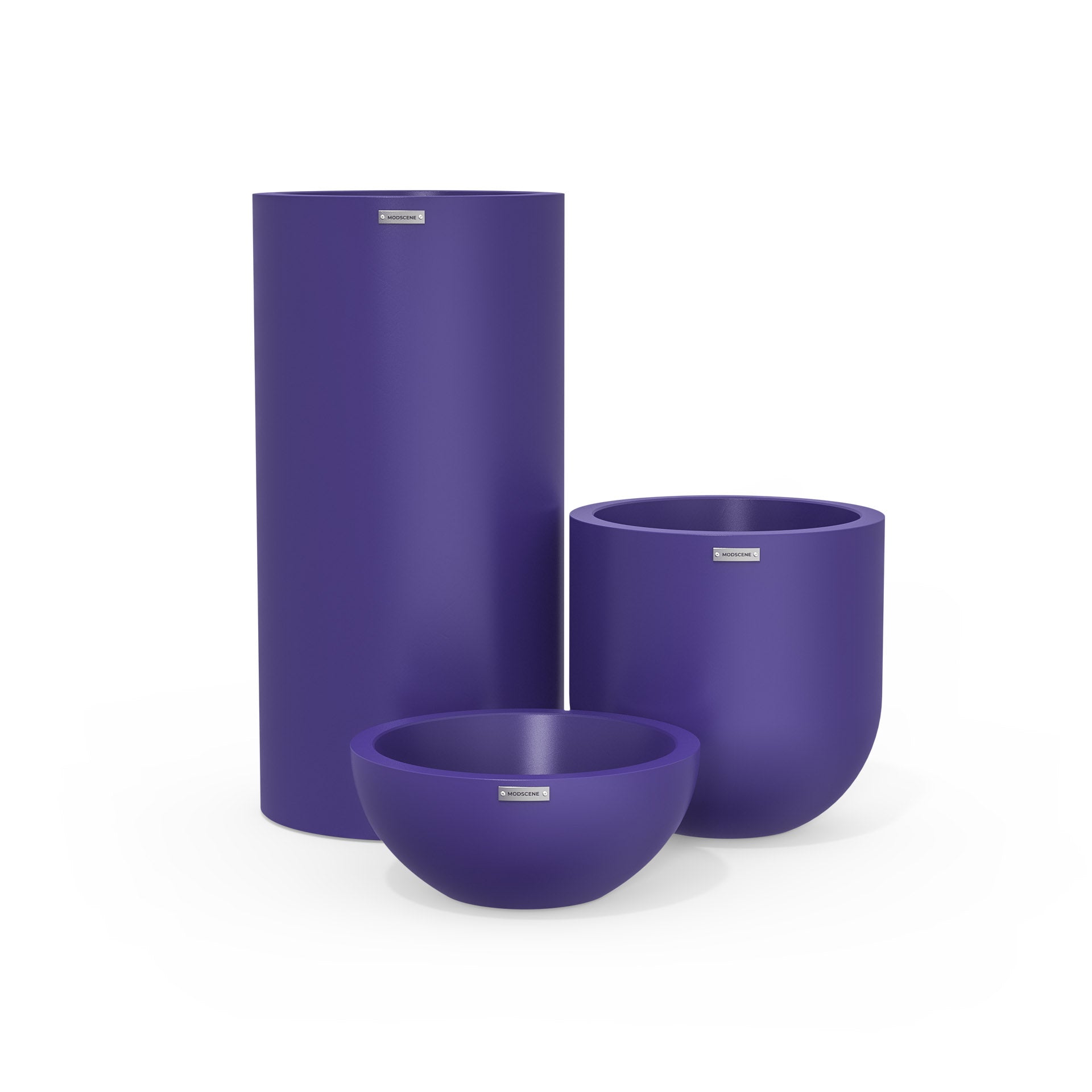 Cluster of three plastic plant pots in bright purple. Beautiful outdoor pots.