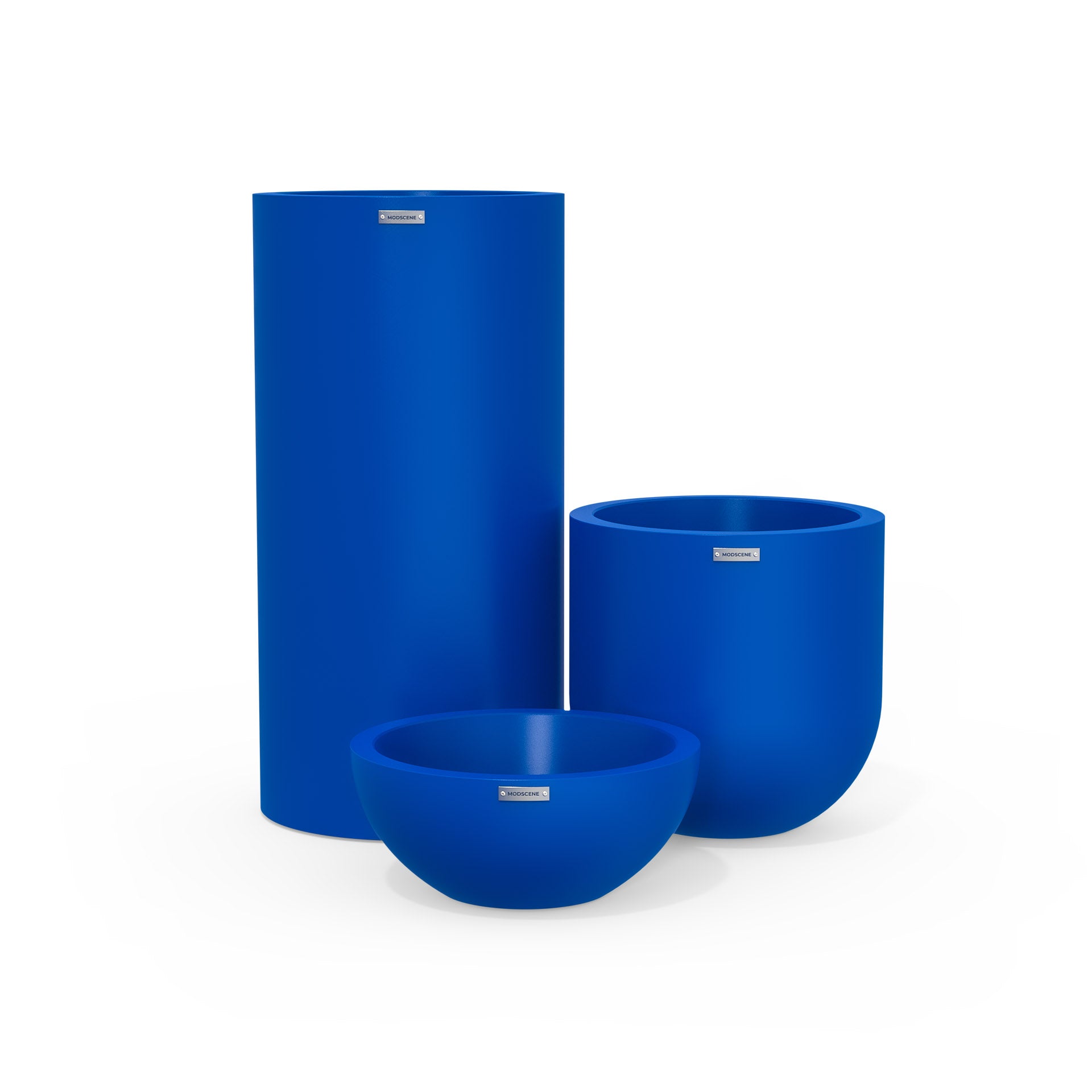 Cluster of three plastic plant pots in a deep blue colour. Modscene designer planters NZ.