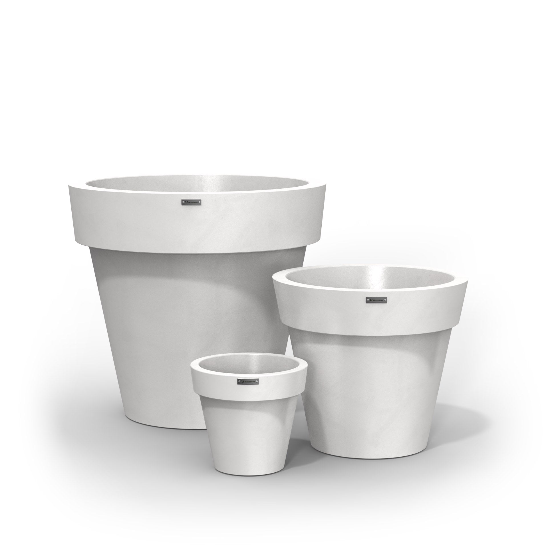 A cluster of three Modscene planter pots in a matte white colour. New Zealand made planters.