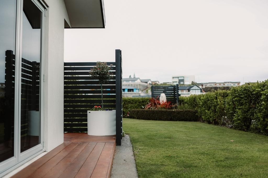 Large white Modscene cylinder planter on a balcony.