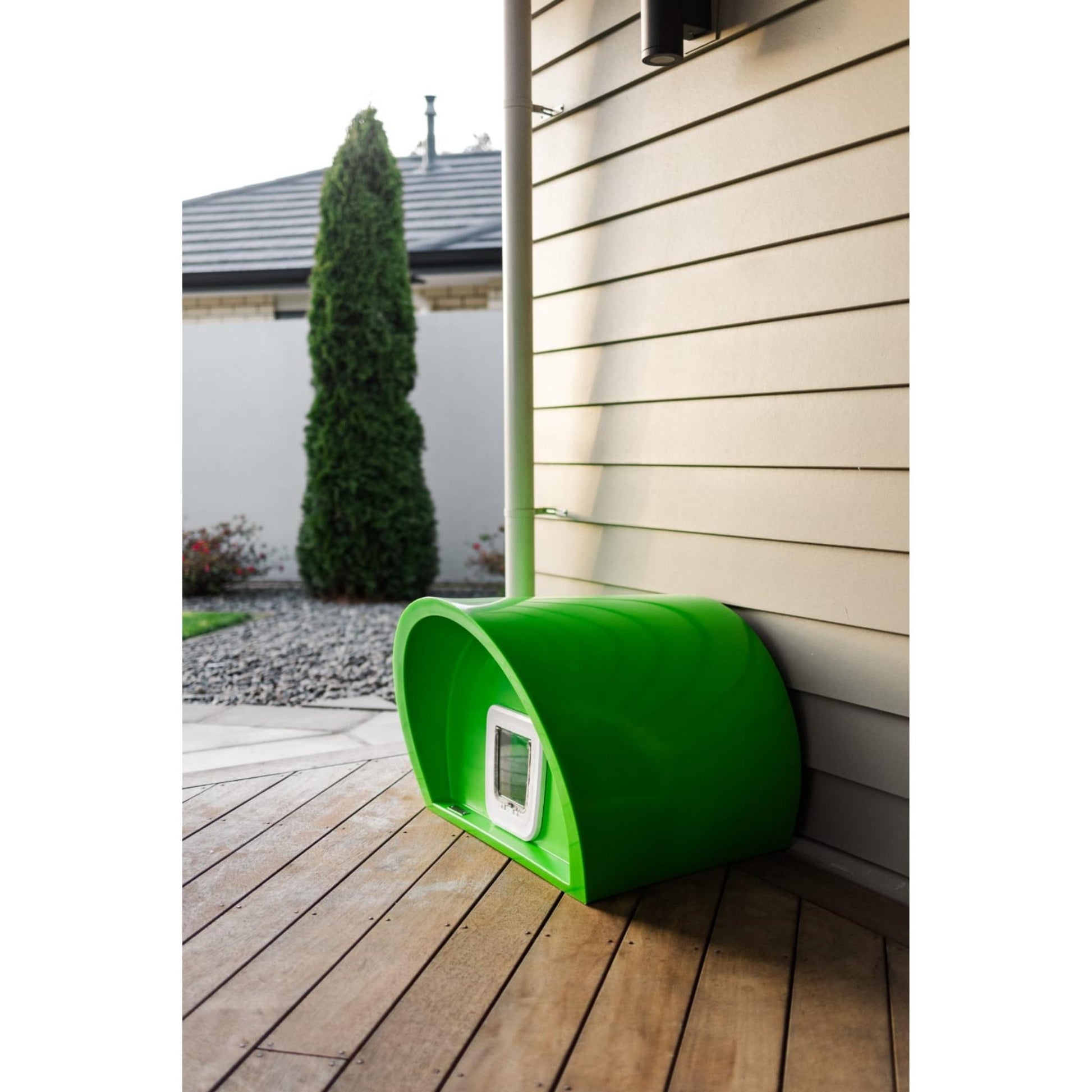 A high quality designer cat house sitting on a deck.