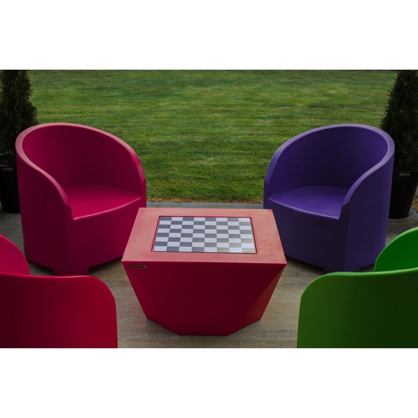 Modscene outdoor furniture on a deck with an outdoor fire in the background.