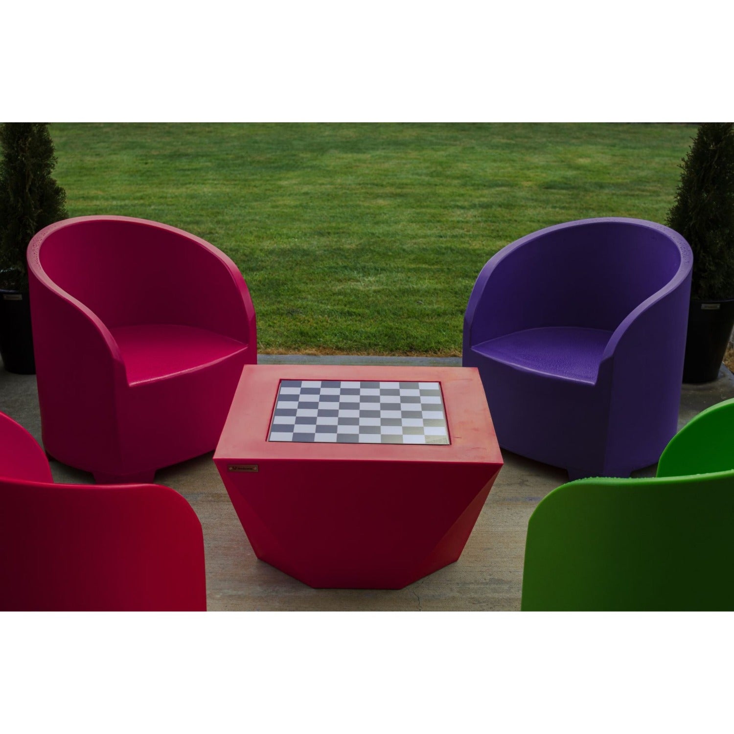 Modscene outdoor furniture on a deck with an outdoor fire in the background.