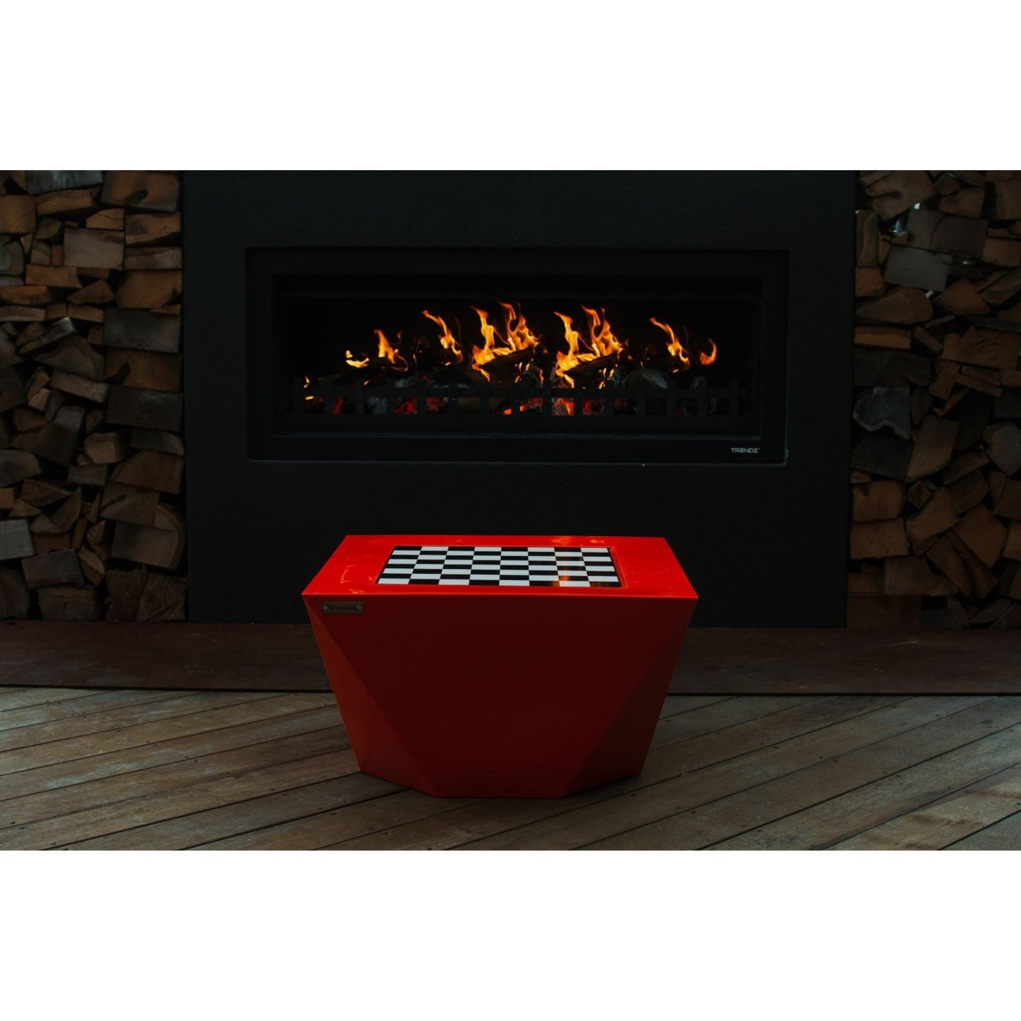 Modscene outdoor furniture on a deck with an outdoor fire in the background.