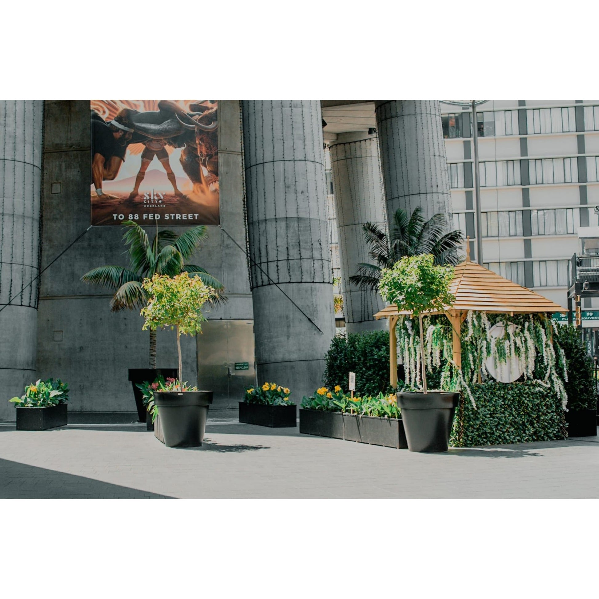 Large black planters in a public space. Modscene planters NZ.