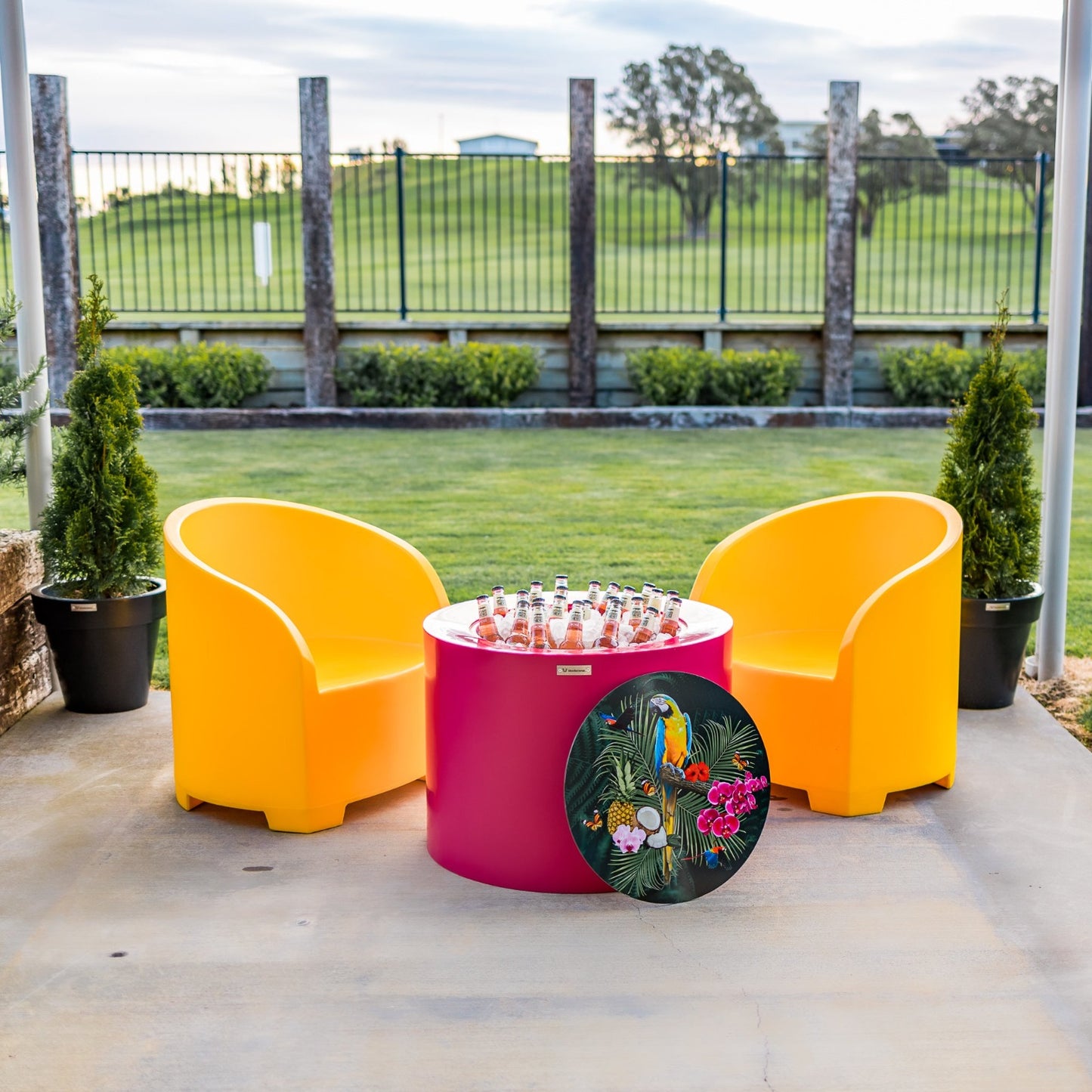 Bright yellow and pink Modscene outdoor furniture on a patio. Outdoor furniture New Zealand.