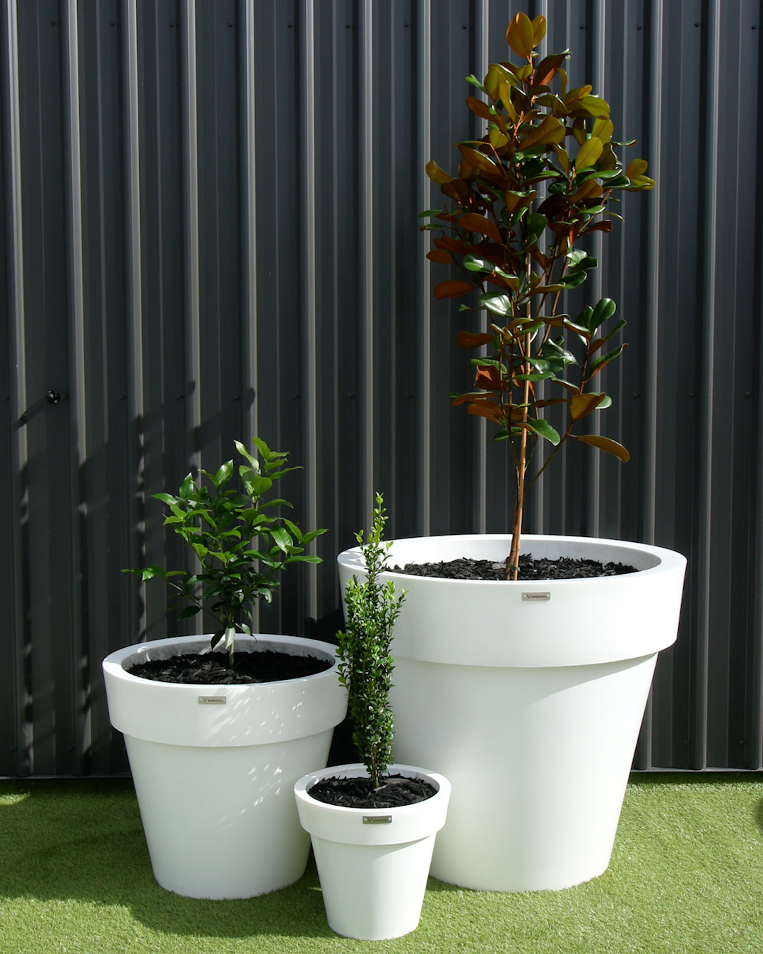 White planter cluster. Cluster of white pot plants.