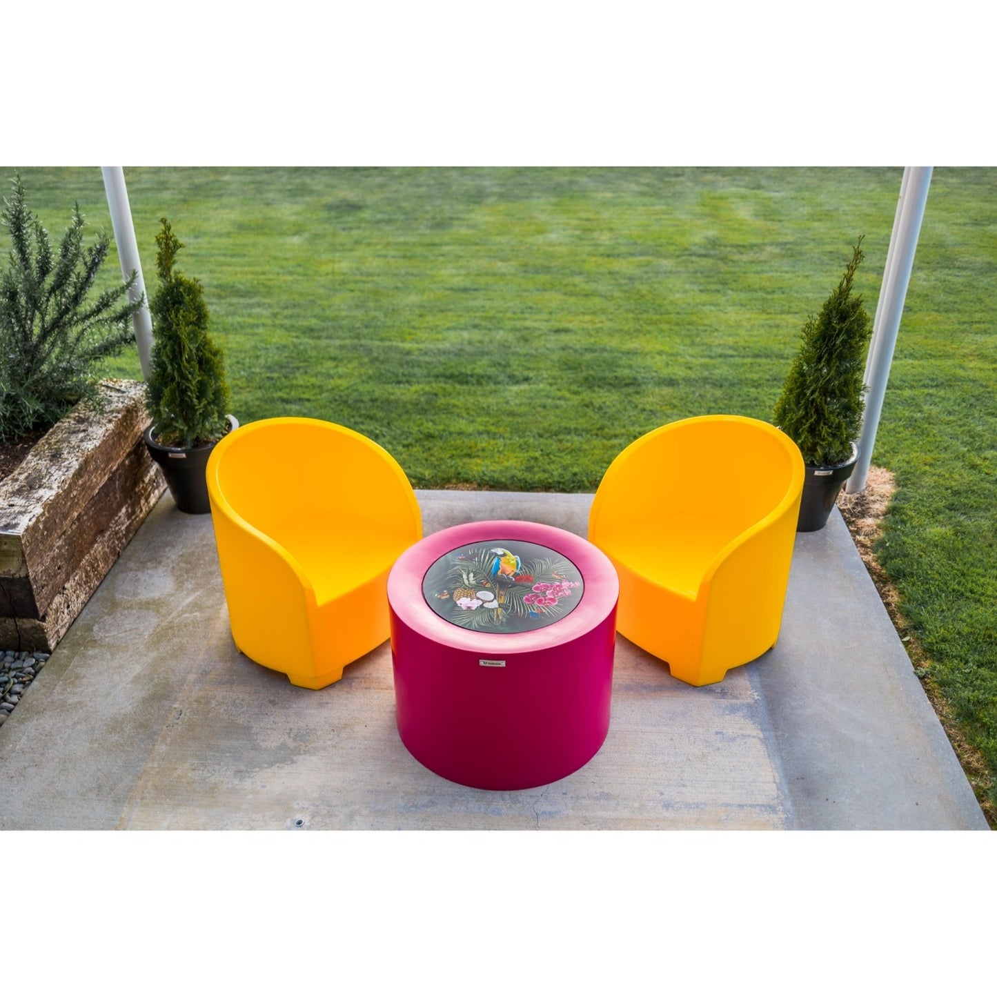 Bright Modscene outdoor furniture on a concrete patio.