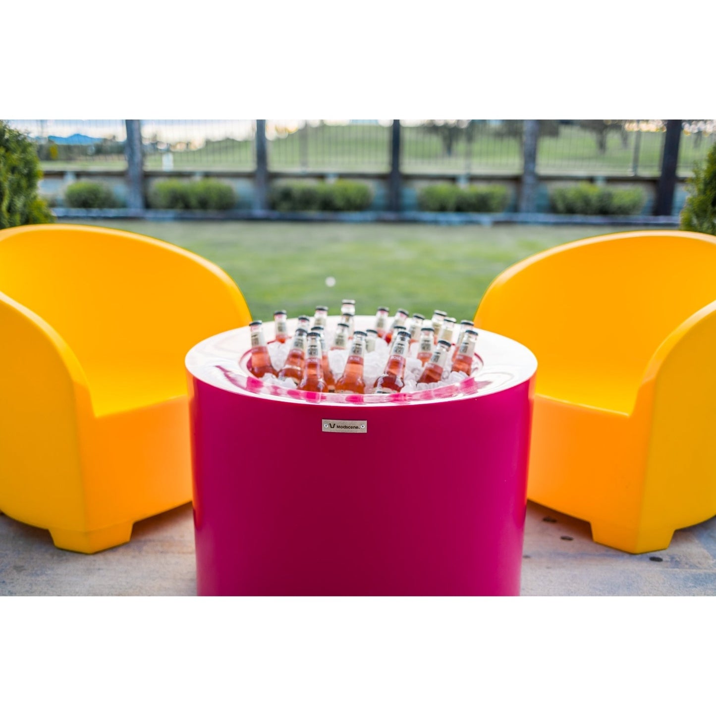 Bright yellow and pink Modscene outdoor furniture on a patio. Outdoor furniture New Zealand.