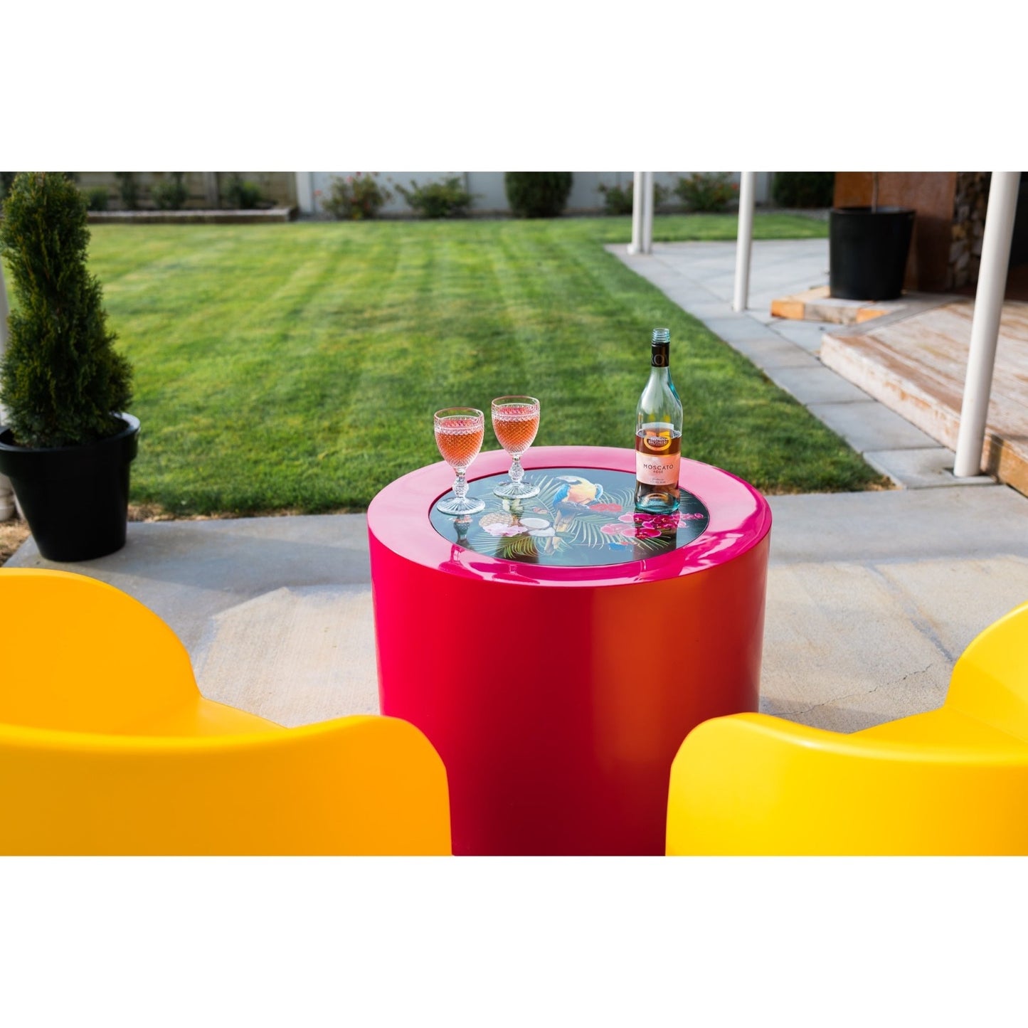Bright yellow and pink Modscene outdoor furniture on a patio. Outdoor furniture New Zealand.