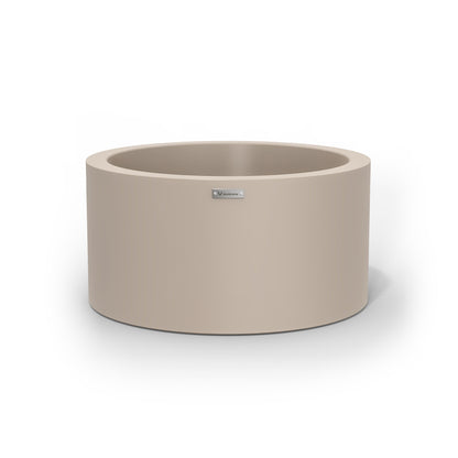A medium cylinder shaped pot planter in a sand stone colour.