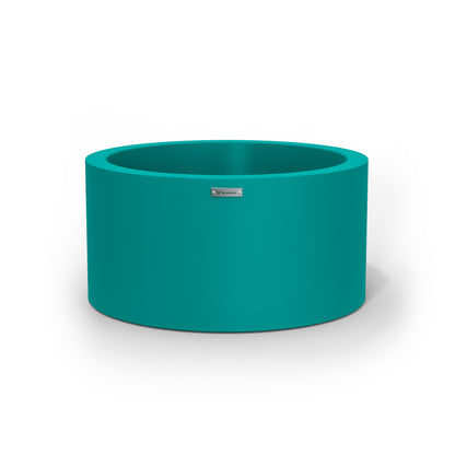A medium cylinder shaped pot planter in teal made by Modscene NZ. 