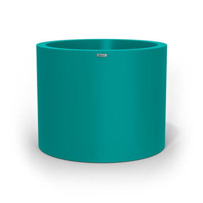 A giant cylinder pot planter in a teal colour. Made in NZ.