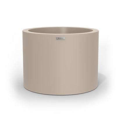 A cylinder shaped pot planter in a sand stone colour.