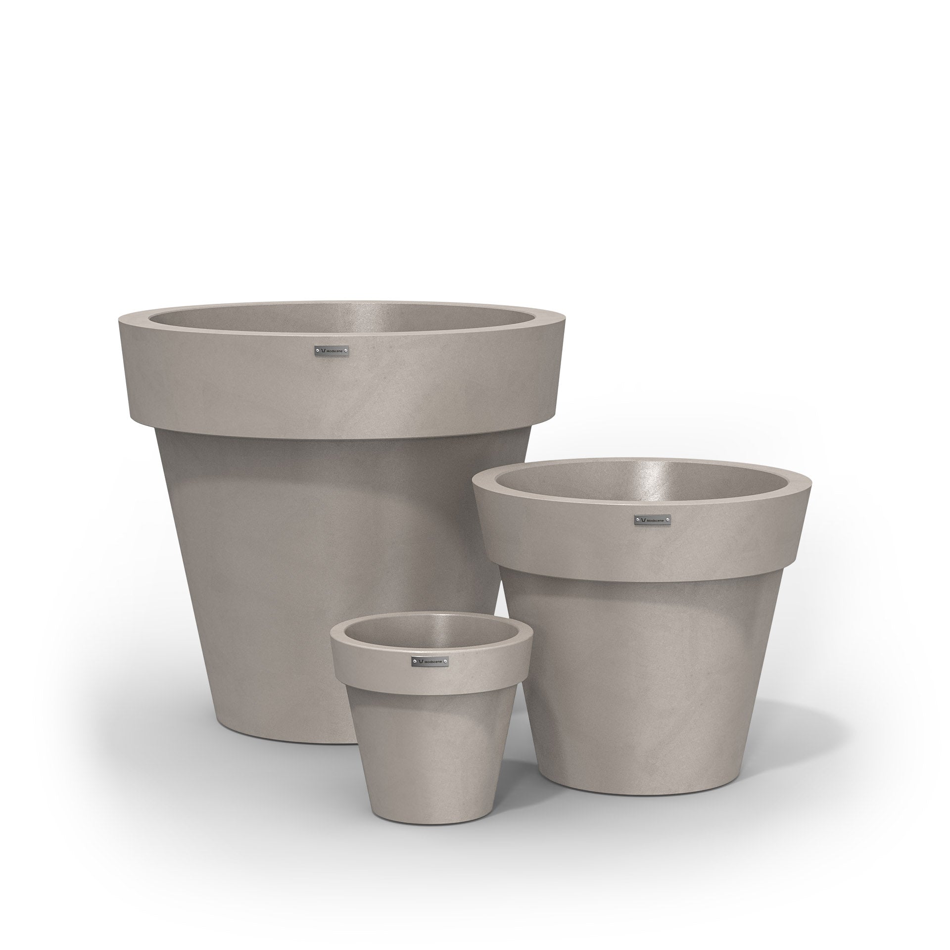A cluster of three Modscene planters pots in a sandstone colour with a concrete look.