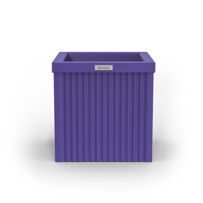 A corrugated square planter pot. The pot planter is purple in colour.