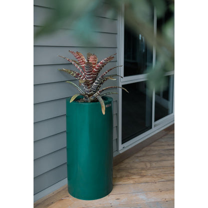 Emerald green Modscene cylinder planter pot on a veranda.