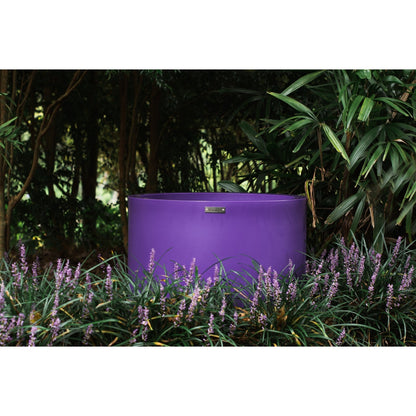large purple pot planter in a garden. Cylinder planter pots New Zealand.