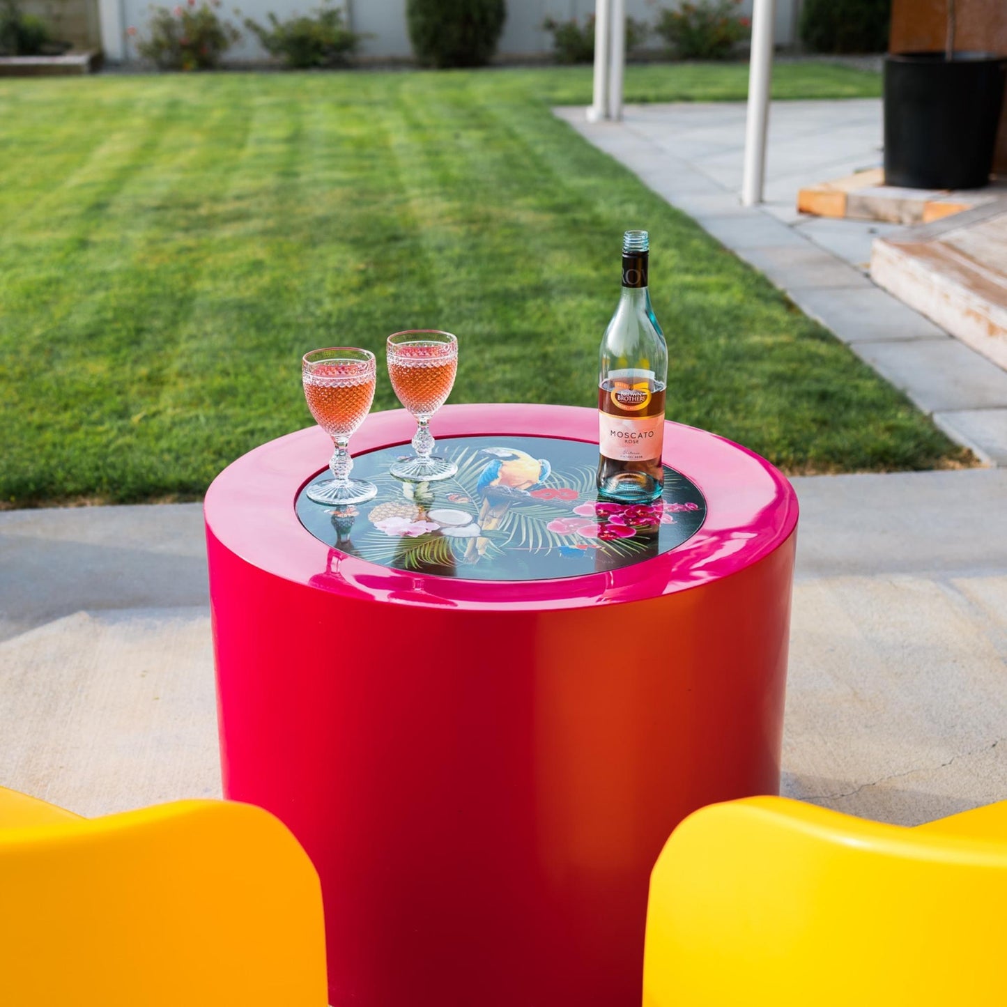 A pink cylinder shaped outdoor table.
