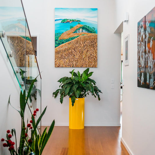 Large yellow planter pot in a house hallway.