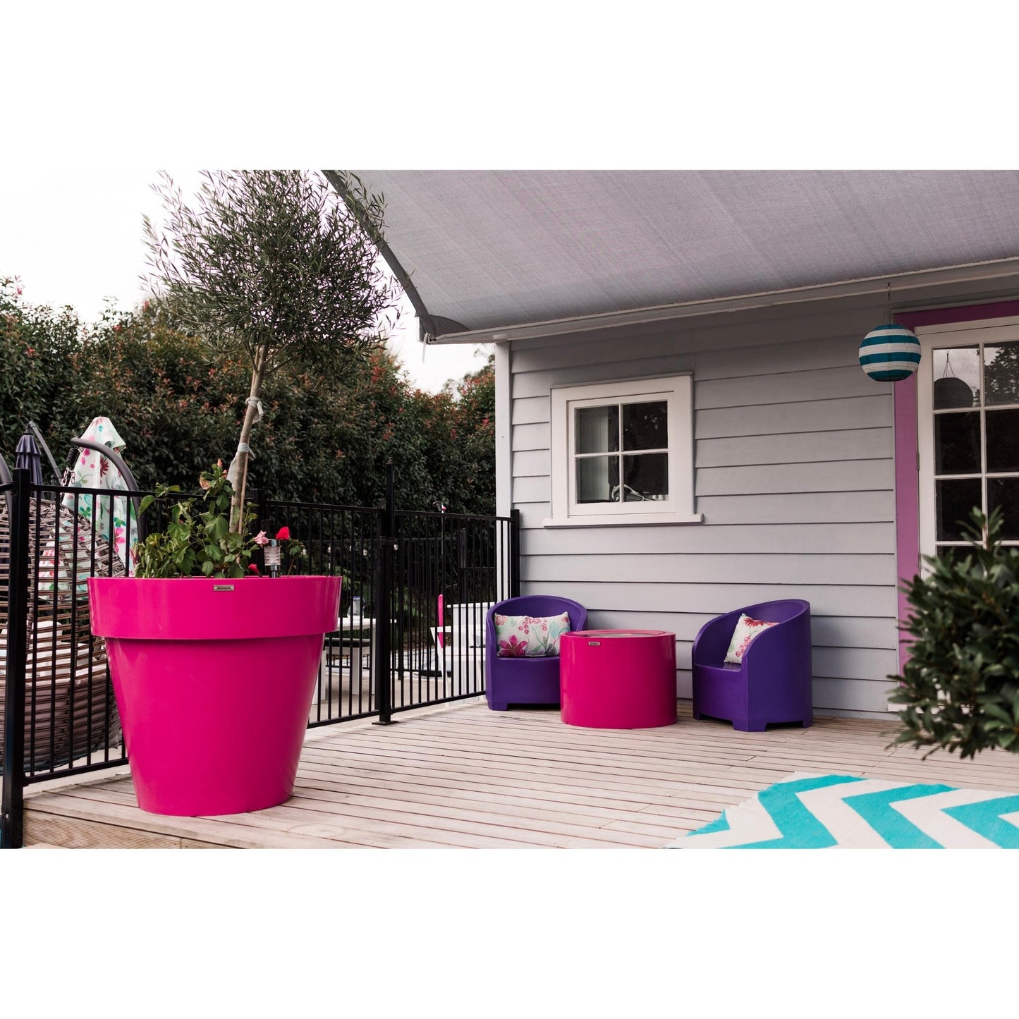 A giant pink planter on a deck with some Modscene outdoor furniture.