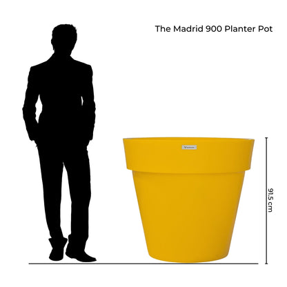An illustration of a Modscene Madrid 900 planter by a person.